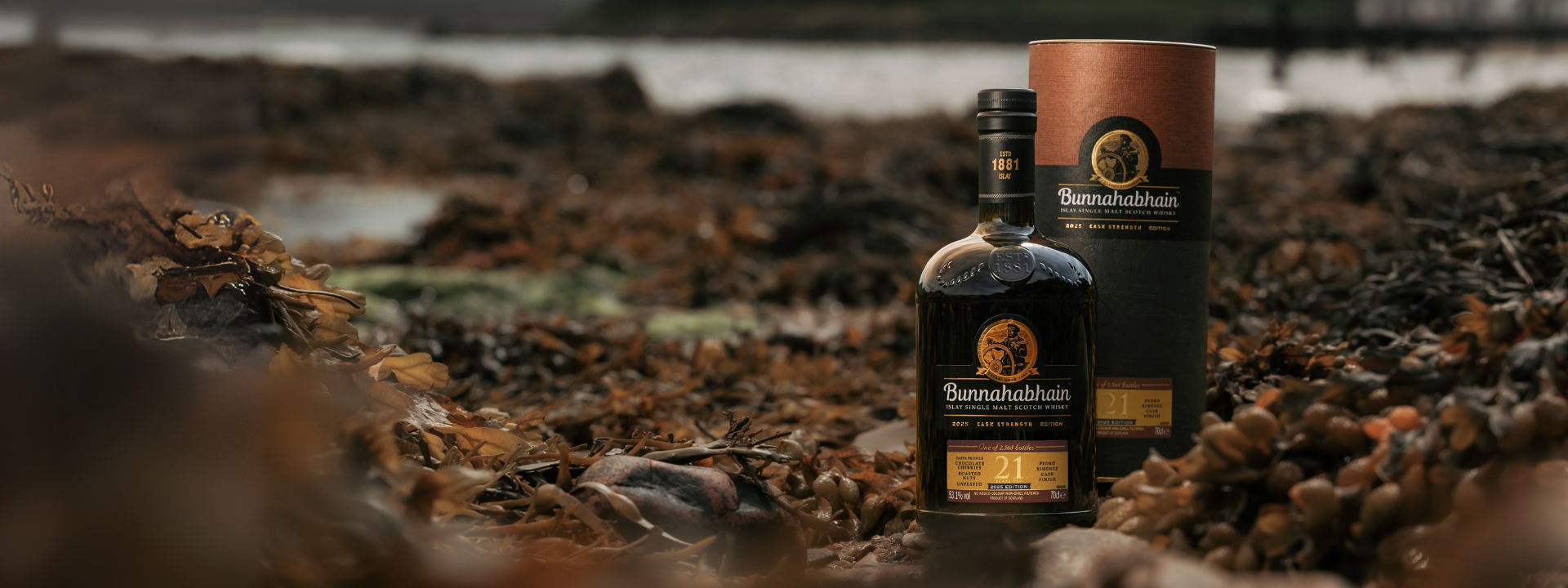 21 Year Old Cask Strength 2025 Edition Bottle and Pack in Bunnahabhain Bay