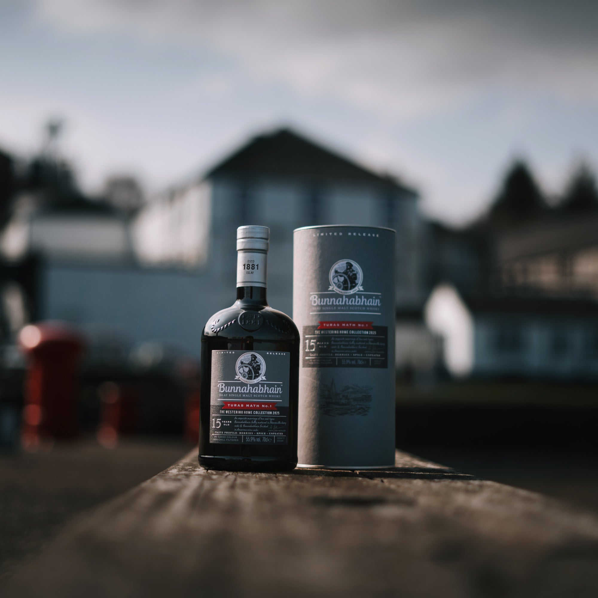 Bunnahabhain Turas Math No.1 on Bunnahabhain Pier with pack and distillery backdrop.