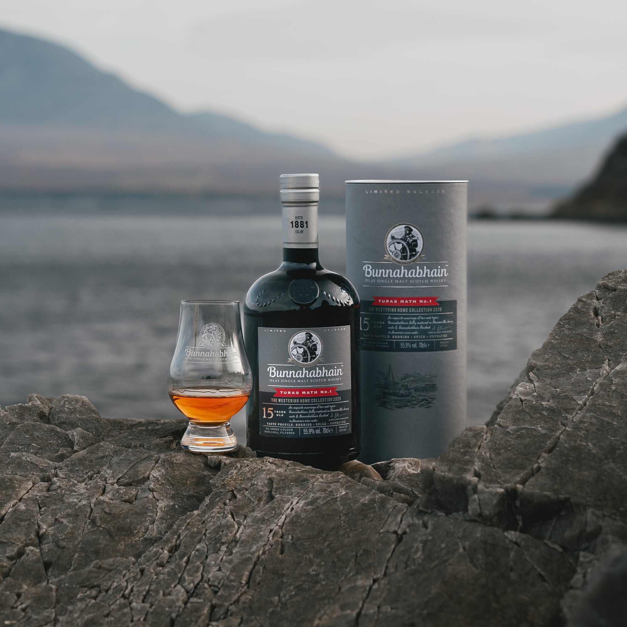 Bunnahabhain Turas Math No.1 sitting on rocks with a dram and pack