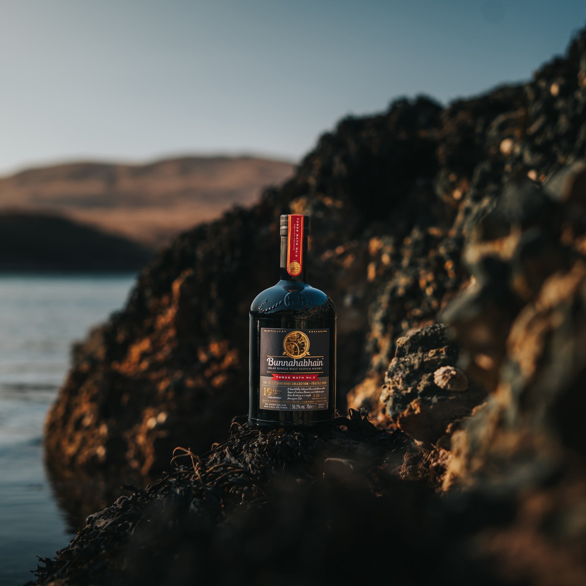 Bunnahabhain Turas Math No.3 bottle sitting on rocks
